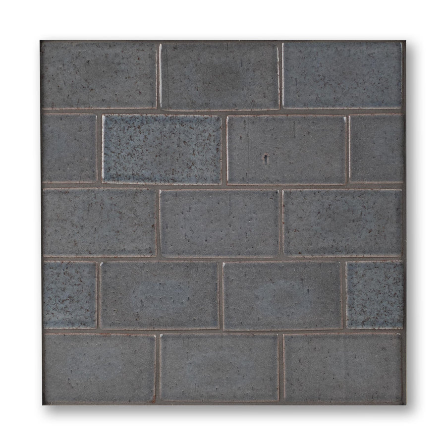 Dark blue-gray brick tile on a white background